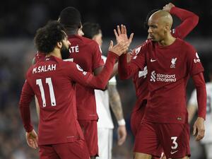 Liverpool's Egyptian striker Mohamed Salah (L) celebrates with Liverpool's Brazilian midfielder Fabinho (R) after scoring their second goal during the English Premier League football match between Leeds United and Liverpool at Elland Road in Leeds, northern England on April 17, 2023. (Photo by Oli SCARFF / AFP)
