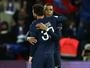 Paris Saint-Germain's Argentine forward Lionel Messi is congratulated by Paris Saint-Germain's French forward Kylian Mbappe after scoring his team's third goal during the French L1 football match between Paris Saint-Germain (PSG) and Lens (RCL) at the Parc des Princes in Paris, on April 15, 2023. (Photo by Anne-Christine POUJOULAT / AFP)