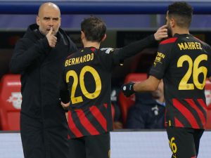 Manchester City's Spanish manager Pep Guardiola (L) gives instructions to Manchester City's Portuguese midfielder Bernardo Silva (C) and Manchester City's Algerian midfielder Riyad Mahrez (R) from the sidelines during the UEFA Champions League round of 16, first-leg football match between RB Leipzig and Manchester City in Leipzig, eastern Germany on February 22, 2023. (Photo by Odd ANDERSEN / AFP)