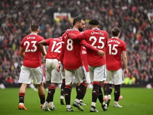 Manchester United's Portuguese midfielder Bruno Fernandes celebrates with Manchester United's English striker Jadon Sancho after scoring his team first goal during the English Premier League football match between Manchester United and Aston Villa at Old Trafford in Manchester, north west England, on April 30, 2023. (Photo by Oli SCARFF / AFP) 