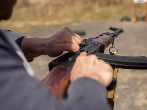 Iraqi brandishing rifle shoots at passers-by