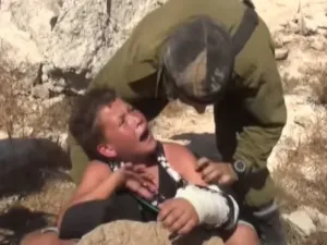 جندي اسرائيلي خلال تنكيله بطفل فلسطيني في الضفة الغربية