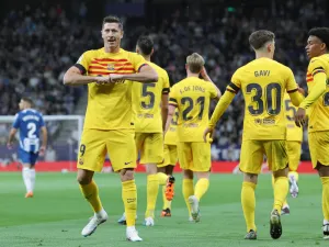 Barcelona's Polish forward Robert Lewandowski (L) celebrates scoring the opening goal during the Spanish league football match between RCD Espanyol and FC Barcelona at the RCDE Stadium in Cornella de Llobregat on May 14, 2023. (Photo by Lluis GENE / AFP)