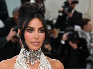 Kardashian is seen cradling a baby bump