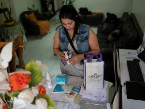 Maria Sanchez, 50, shows the medicines she needs to take after her second biopolymer extraction operation, in Caracas on Aug 4, 2023. (Photo by Magda Gibelli / AFP Biopolymer