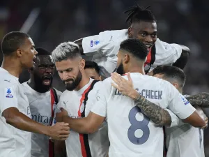 AC Milan's French forward #09 (3rd L) Olivier Giroud celebrates with teammates after scoring his team's first goal during the Italian Serie A football match between AS Roma and AC Milan at the Olympic stadium in Rome on September 1, 2023. (Photo by Filippo MONTEFORTE / AFP)