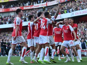Arsenal's Brazilian striker #09 Gabriel Jesus celebrates with teammates after scoring their third goal during the English Premier League football match between Arsenal and Manchester United at the Emirates Stadium in London on September 3, 2023. (Photo by Glyn KIRK / AFP)