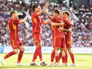 AS Roma's Argentinian forward Paulo Dybala (C) is congratulated by teammates after scoring the team's first goal during a friendly football match between Toulouse (TFC) and AS Roma (ASR) at the Stadium TFC in Toulouse, southwestern France, on August 6, 2023. (Photo by Charly TRIBALLEAU / AFP)