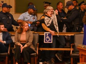 Susan Abulhawa being violently escorted out of Philadelphia City hall. (Joe Piette)