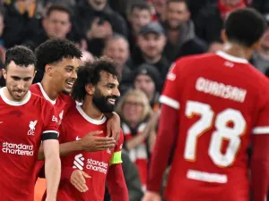Liverpool's Egyptian striker #11 Mohamed Salah (C) celebrates scoring the team's fifth goal during the UEFA Europa League group E football match between Liverpool and Toulouse at Anfield in Liverpool, north west England on October 26, 2023. Liverpool won the match 5-1. (Photo by Oli SCARFF / AFP)