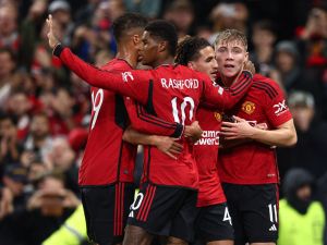 Manchester United's Danish striker #11 Rasmus Hojlund (R) celebrates scoring the opening goal during the UEFA Champions league group A football match between Manchester United and Galatasaray at Old Trafford stadium in Manchester, north west England, on October 3, 2023. (Photo by Darren Staples / AFP)