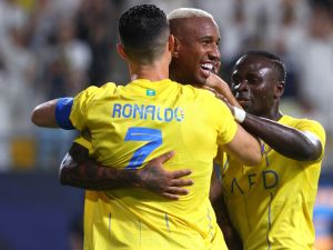 Nassr's Brazilian forward #94 Talisca (C) celebrates after scoring a goal with teammates Nassr's Portuguese forward #07 Cristiano Ronaldo and Nassr's Senegalese Forward #10 Sadio Mane (R) during the AFC Champions League Group E football match between Saudi's al-Nassr and Qatar’s al-Duhail at the King Saud University Stadium in Riyadh on October 24, 2023. (Photo by Fayez NURELDINE / AFP)