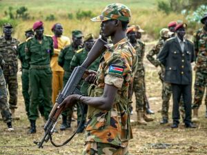 A South Sudanese soldier monitors the area as troops belonging to the South Sudanese Unified Forces take part in a deployment ceremony. (Louis Gume/AFP)