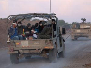Israeli soldiers transfer detained Palestinians out of the Gaza Strip on November 20, 2023. (Gil Cohen Magen/ AFP)