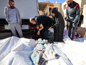 A woman mourns during the funeral of Al Hajj family at the Al-Aqsa Hospital in Deir el-Balah, in the central Gaza Strip on November 21, 2023. (Mahmud Hams/ AFP)