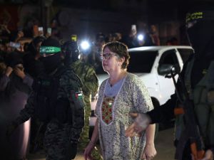 Hamas fighters accompanying a newly released Israeli hostage. (AFP)