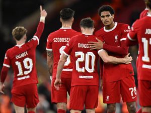 Liverpool's Portuguese striker #20 Diogo Jota (C) celebrates with teammates after scoring their second goal during the UEFA Europa League group E football match between Liverpool and Royale Union Saint-Gilloise at Anfield in Liverpool, north west England on October 5, 2023. Liverpool won the game 2-0. (Photo by Oli SCARFF / AFP)