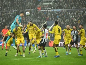 Newcastle United's English goalkeeper #22 Nick Pope (L) heads the ball as he fights for it with Dortmund’s German midfielder #17 Marius Wolf during the UEFA Champions League Group F football match between Newcastle United and Borussia Dortmund at St James' Park in Newcastle-upon-Tyne, north east England, on October 25, 2023. (Photo by Oli SCARFF / AFP)