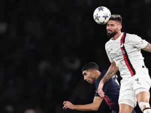 AC Milan's French forward #09 Olivier Giroud heads the ball next to Paris Saint-Germain's Moroccan defender #02 Achraf Hakimi during the UEFA Champions League Group F football match between Paris Saint-Germain (PSG) and AC Milan at the Parc de Princes in Paris on October 25, 2023. (Photo by FRANCK FIFE / AFP)