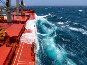 Cargo ship rolling in stormy sea