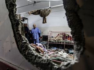 People inspect the damage in a room following Israeli bombardment at Nasser hospital in Khan Yunis in the southern Gaza Strip. (Stringer/ AFP)