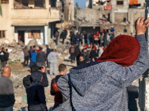 Israel bombs Gaza: People gather to inspect the rubble of a building destroyed by Israeli bombardment in southern Gaza on December 19, 2023. (Mohammed Abed/ AFP)