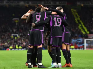 Bayern Munich's players celebrate the opening goal scored by Bayern Munich's French forward #11 Kingsley Coman during the UEFA Champions League group A football match between Manchester United and FC Bayern Munich at Old Trafford stadium in Manchester, north west England, on December 12, 2023. (Photo by PETER POWELL / AFP)