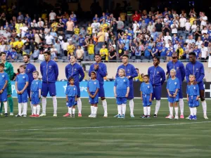 Chelsea players stand for their national anthem ahead of a pre-season friendly football match between Chelsea FC and Borussia Dortmund BVB at Soldier Field in Chicago, Illinois, on August 2, 2023. (Photo by KAMIL KRZACZYNSKI / AFP)