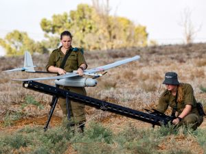 An Israeli soldier prepares an Elbit Systems Skylark I unmanned aerial vehicle (UAV or drone) for take-off near the border with the Gaza Strip in southern Israel on August 21, 2020, as part of monitoring operations in the area. / AFP
