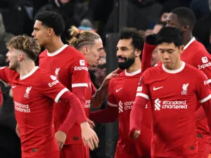 Liverpool's Egyptian striker #11 Mohamed Salah (C) celebrates with teammates after scoring their third goal during the UEFA Europa League group E football match between Liverpool and Linzer ASK at Anfield in Liverpool, north west England on November 30, 2023. (Photo by Oli SCARFF / AFP)