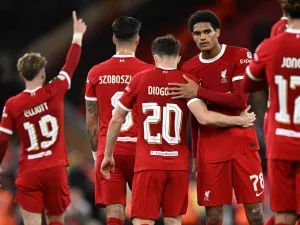 Liverpool's Portuguese striker #20 Diogo Jota (C) celebrates with teammates after scoring their second goal during the UEFA Europa League group E football match between Liverpool and Royale Union Saint-Gilloise at Anfield in Liverpool, north west England on October 5, 2023. Liverpool won the game 2-0. (Photo by Oli SCARFF / AFP)