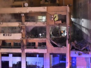 People inspect the site of a strike, reported by Lebanese media to be an Israeli strike targeting a Hamas office, in the southern suburb of Beirut. (AFP)