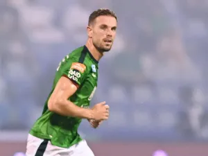 Ettifaq's English midfielder #10 Jordan Henderson runs past Nassr's Senegalese Forward #10 Sadio Mane during the Saudi Pro League football match between Al-Ettifaq and Al-Nassr at the Prince Mohamed bin Fahd Stadium in Dammam on August 14, 2023. (Photo by Ali Alhaji / AFP)