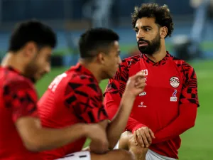 Egypt's forward Mohamed Salah (R) warms up before the start of the friendly football match between Belgium and Egypt at the Jaber Al-AhmadQ Stadium in Kuwait City on November 18, 2022. (Photo by YASSER AL-ZAYYAT / AFP)