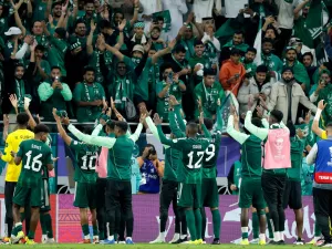 Saudi Arabia's players celebrate with their supporters after the Qatar 2023 AFC Asian Cup Group F football match between Kyrgyzstan and Saudi Arabia at the Ahmad Bin Ali Stadium in Al-Rayyan, west of Doha on January 21, 2024. (Photo by KARIM JAAFAR / AFP)