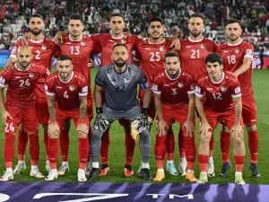 Syria's starting eleven pose for the group photo before the start of the Qatar 2023 AFC Asian Cup Group B football match between Uzbekistan and Syria at the Jassim bin Hamad Stadium in Doha on January 13, 2024. (Photo by HECTOR RETAMAL / AFP)