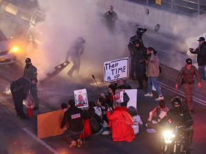 Israeli security forces disperse supporters and families of hostages held in Gaza since the October 7 attacks after they blocked the Ayalon highway in Tel Aviv calling for their release on February 10, 2024