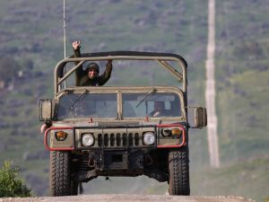 An Israeli military vehicle makes its way through the Israeli-annexed Golan Heights near the border with Lebanon, on February 27, 2024,