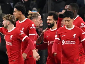 Liverpool's Egyptian striker #11 Mohamed Salah (C) celebrates with teammates after scoring their third goal during the UEFA Europa League group E football match between Liverpool and Linzer ASK at Anfield in Liverpool, north west England on November 30, 2023. (Photo by Oli SCARFF / AFP)