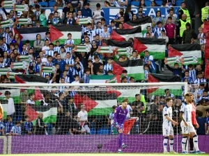 Supporters hold Palestinian flags during the Spanish league football match between Real Sociedad and RCD Mallorca at the Reale Arena stadium in San Sebastian on October 21, 2023. (Photo by ANDER GILLENEA / AFP)