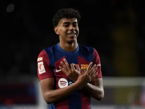 Barcelona's Spanish forward #27 Lamine Yamal celbrates scoring the opening goal during the Spanish league football match between FC Barcelona and Granada FC at the Estadi Olimpic Lluis Companys in Barcelona on February 11, 2024. (Photo by Josep LAGO / AFP)