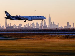 A Boeing 787-9 Dreamliner passenger aircraft of Air New Zealand arrives from Auckland at JFK International Airport in New York as the Manhattan skyline looms in the background on February 5, 2024. (Photo by Charly TRIBALLEAU / AFP) New Zealand