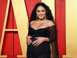 Vanessa Hudgens reveals on Oscars red carpet that she's pregnant with her first baby. (Photo by Michael TRAN / AFP)
