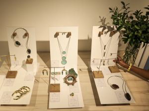 A staff member arranges a display of Kenyan designer Ami Doshi Shah's hand-crafted jewelry at a showcase of designs by several local artists. (Photo by Tony KARUMBA / AFP) Kenya