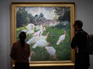 Visitors stand in front of the painting "Les Dindons" (The Turkeys - 1876) by French impressionist painter Claude Monet. (Photo by MIGUEL MEDINA / AFP)  virtual reality
