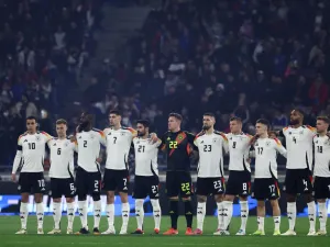 Germany's players observe a minute's silence for former German International players Franz Beckenbauer and Andreas Brehme, ahead of the friendly football match between France and Germany, at the Groupama Stadium in Decines-Charpieu, near Lyon, on March 23, 2024. (Photo by FRANCK FIFE / AFP)