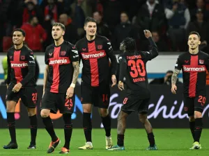 Bayer Leverkusen's Czech forward #14 Patrik Schick (C) celebrates scoring the 3-2 goal with team mates during the UEFA Europa League Group round of 16, second-leg football match between Bayer 04 Leverkusen and Garabagh in Leverkusen, western Germany on March 14, 2024. (Photo by INA FASSBENDER / AFP)