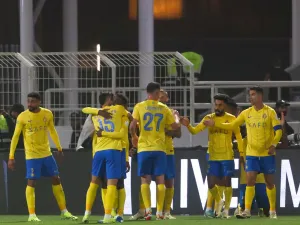 Nassr's players celebrate their team's third goal during the Saudi Pro League football match between Al-Shabab and Al-Nassr at the Al-Shabab Club Stadium in Riyadh on February 25, 2024. (Photo by Fayez NURELDINE / AFP)