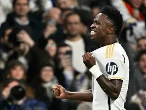 Real Madrid's Brazilian forward #07 Vinicius Junior celebrates scoring the opening goal during the UEFA Champions League last 16 second leg football match between Real Madrid CF and RB Leipzig at the Santiago Bernabeu stadium in Madrid on March 6, 2024. (Photo by JAVIER SORIANO / AFP)
