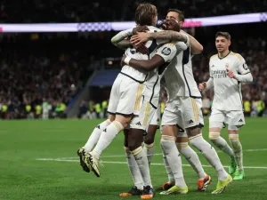 Real Madrid players react to Celta's owngoal during the Spanish league football match between Real Madrid CF and RC Celta de Vigo at the Santiago Bernabeu stadium in Madrid on March 10, 2024. (Photo by Pierre-Philippe MARCOU / AFP)